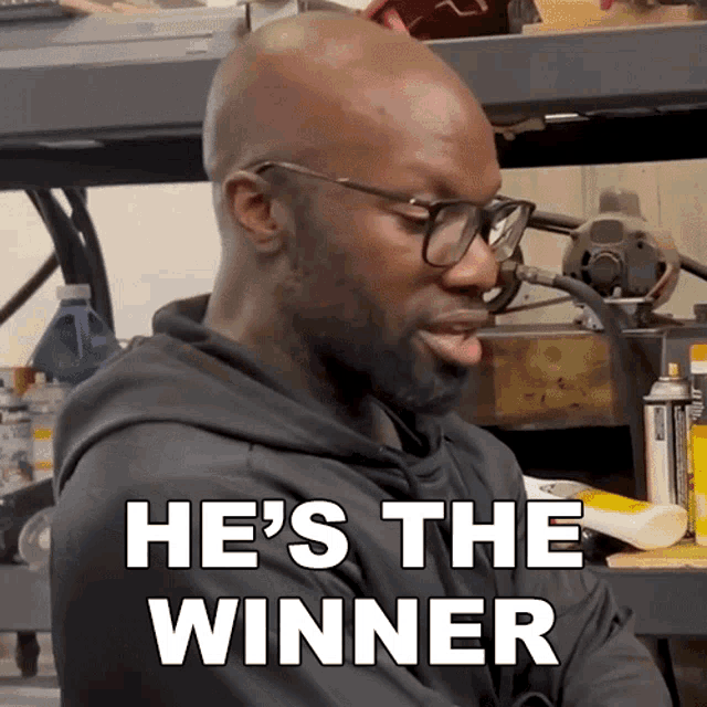 a man wearing glasses and a hoodie says he 's the winner