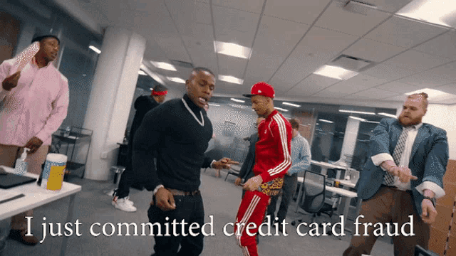 a group of men are dancing in an office with the words i just committed credit card fraud
