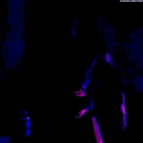 a man with a wrestling belt is standing in the dark
