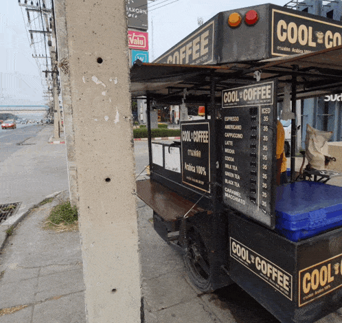 a cool coffee cart is parked on the side of the street