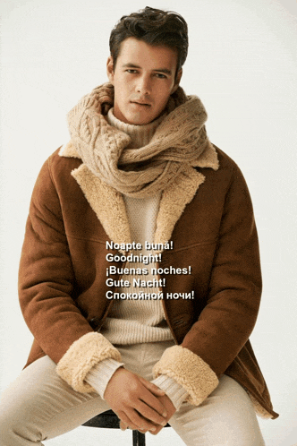 a man with a scarf around his neck is wearing a jacket and sweater and says goodnight
