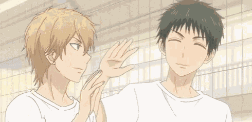 a couple of anime characters are standing next to each other and hugging each other .