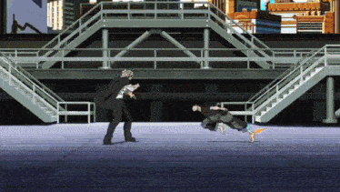 a man in a suit is kicking another man in the stomach