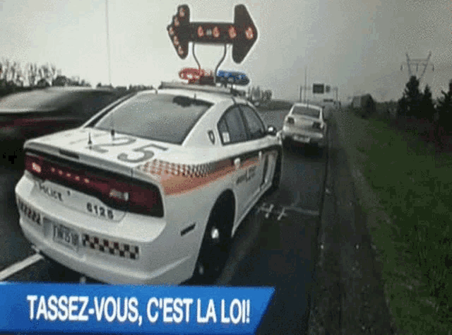 a police car with the number 25 on it is driving down a highway