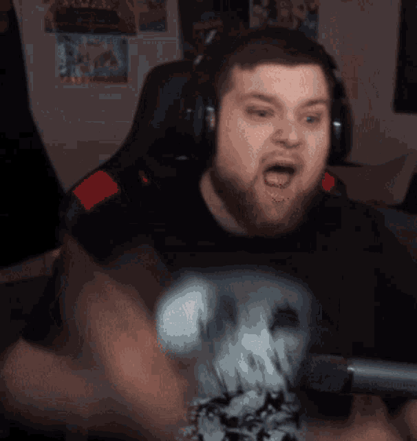 a man with a beard wearing headphones and a skull shirt