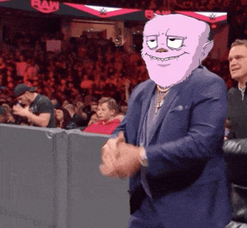 a man in a suit with a pink face is clapping in front of a raw sign