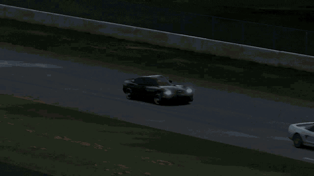 two sports cars are driving on a track and one has a sticker on the back that says ' nsr '