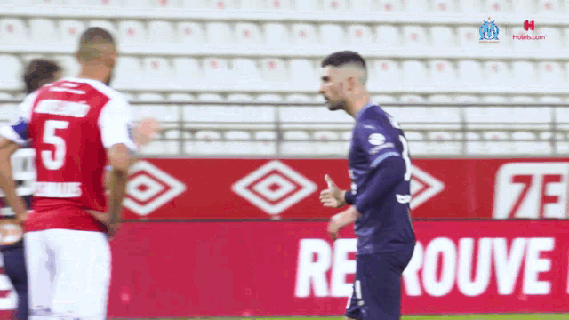 a soccer player with the number 5 on the back of his shirt