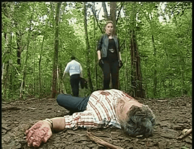 a man is laying on the ground with blood on his hands