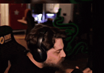 a man wearing headphones is holding a can of beer