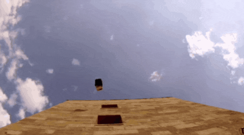 looking up at a brick building with a blue sky and clouds behind it