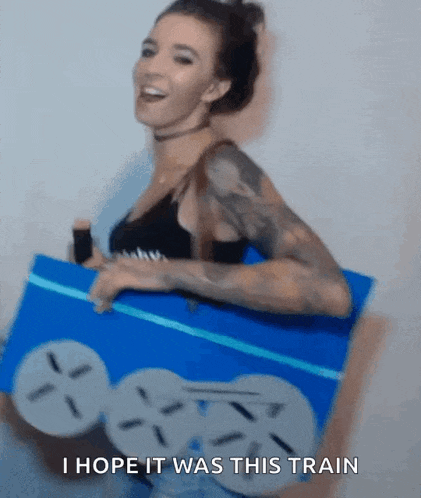 a woman is holding a blue box that says i hope it was this train on it