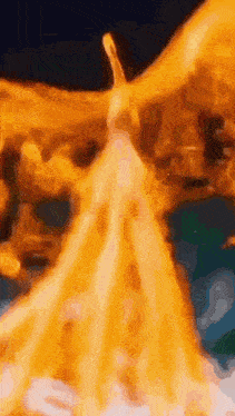 a close up of a statue of a woman in a white dress surrounded by fire .