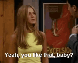 a woman in a yellow tank top is talking to a man in a suit and says yeah you like that baby