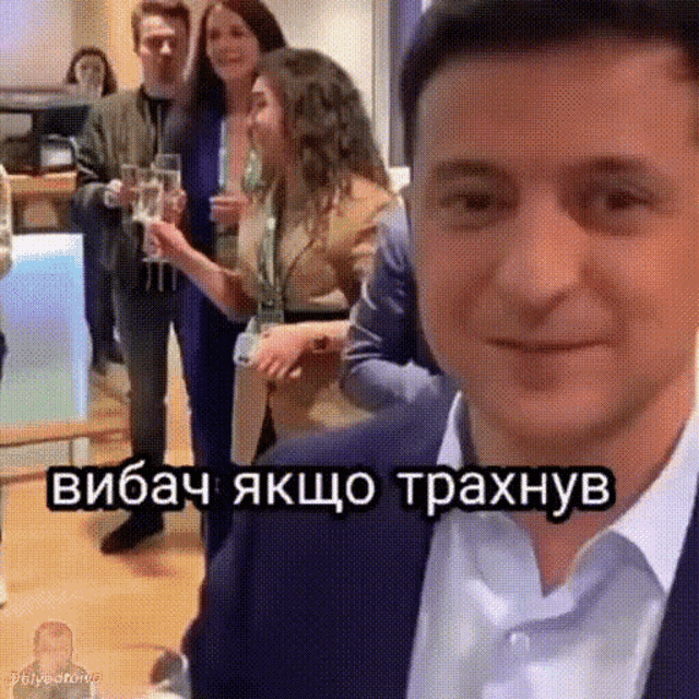 a man in a suit is standing in front of a group of people with a caption that says ' vibach ' on it
