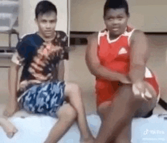 a group of young boys are sitting on a bed .