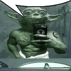 yoda is taking a selfie in the mirror .