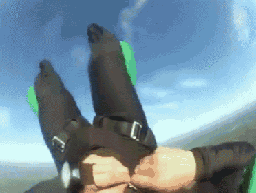 a person is flying through the air with their legs outstretched