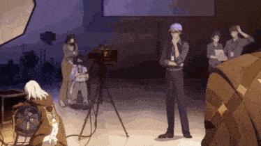 a group of people are standing around a camera in a room