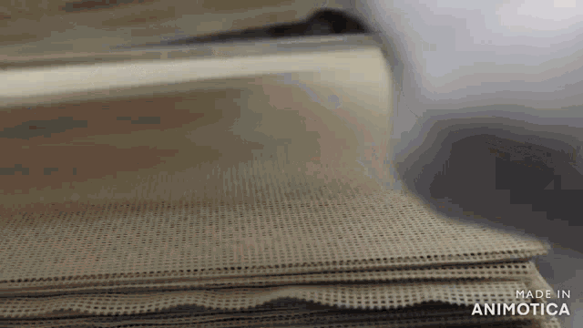 a close up of a stack of paper with the words made in animatica on the bottom