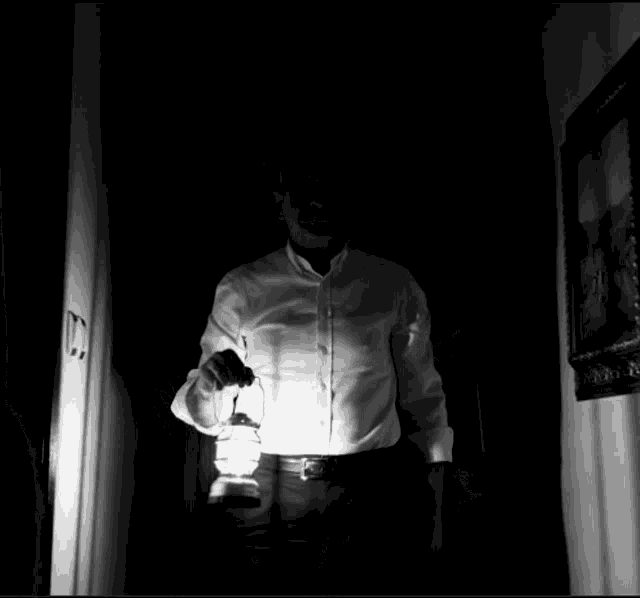 a man in a white shirt is holding a lantern in the dark with the words mehmet59 ile de helallecegiz above him