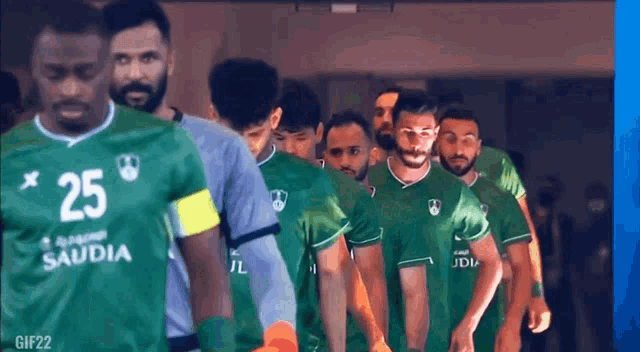 a group of soccer players in green jerseys with the number 25 on the front