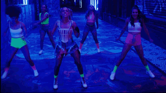 a group of women are dancing in front of a sign that reads grill