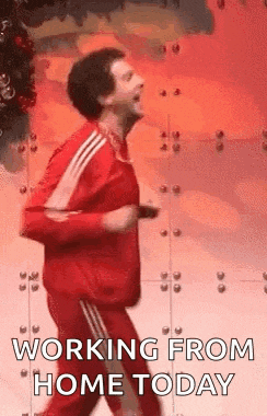 a man in a red jacket and red pants is running .