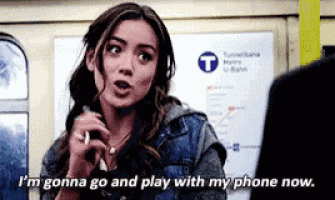 a woman is talking on a cell phone and saying i 'm gonna go and play with my phone now