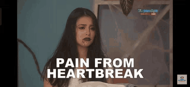 a woman with blood on her face and the words pain from heartbreak on the bottom