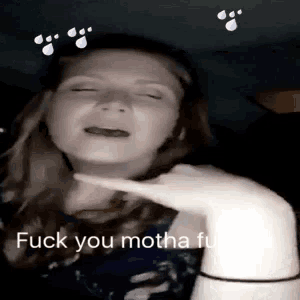 a woman is being slapped in the face with the words `` fuck you motha fuck '' written on the bottom .