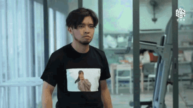 a man in a black shirt with a picture of a woman on it
