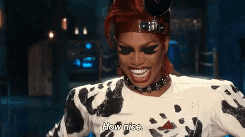 a woman with red hair and a dalmatian print shirt says how nice