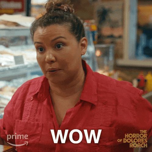 a woman is wearing a red shirt with the word wow on it
