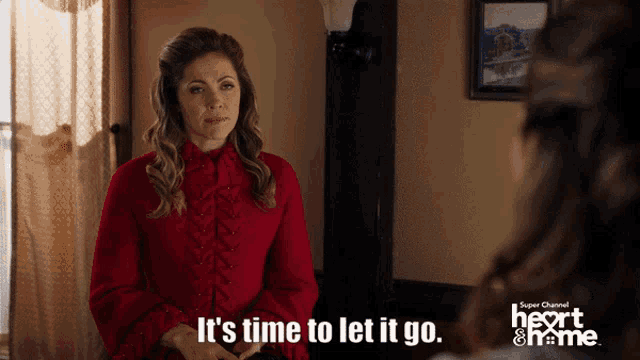 a woman in a red dress says it 's time to let it go in front of a mirror