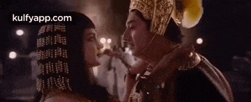 a man and a woman are standing next to each other and kissing .