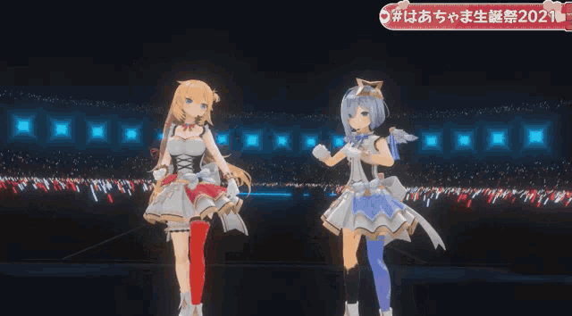 two anime girls are dancing on a stage in front of a crowd