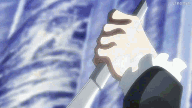 a person is holding a sword in their hand with a blue background behind them .