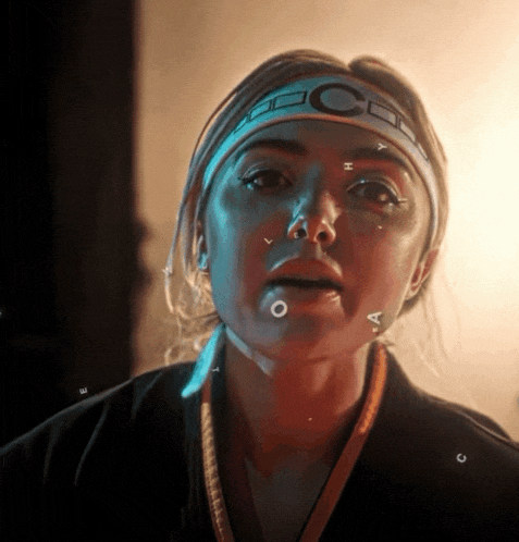 a woman wearing a headband that says cc on it