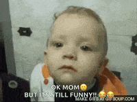 a baby is making a funny face and says `` ok mom but it 's still funny '' .