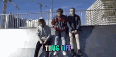 a group of young men sitting on a ramp with the words thug life written above them
