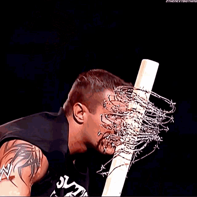 a wrestler with barbed wire coming out of his face