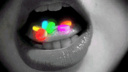 a black and white photo of a person 's mouth with glow in the dark pills in it