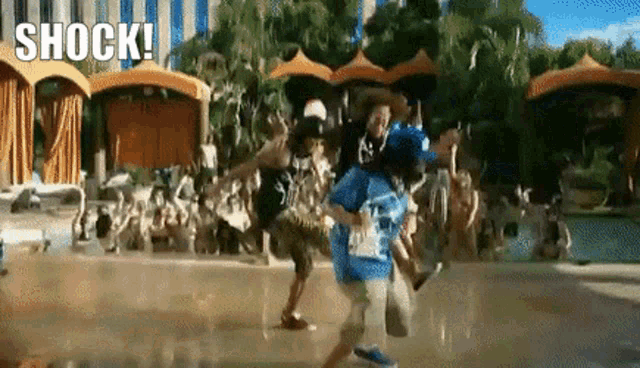 a group of people are dancing in a pool and the words shock are visible in the background