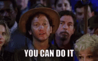 a man in a cowboy hat is sitting in a crowd of people and says `` you can do it '' .