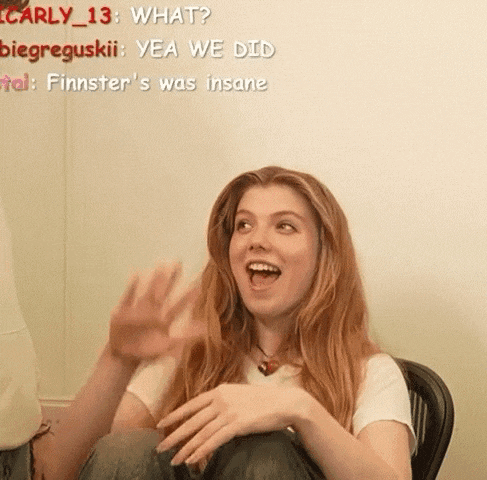 a girl with red hair is sitting in a chair with her mouth open and the words what written above her