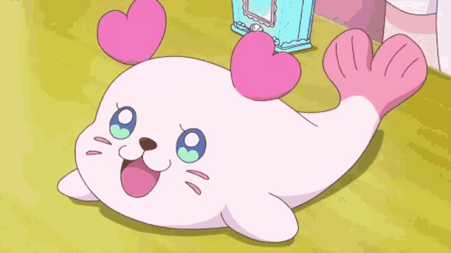 a cartoon seal with pink hearts on its head