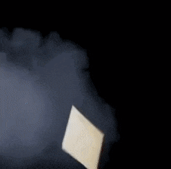 a piece of paper is floating in the air with smoke coming out of it
