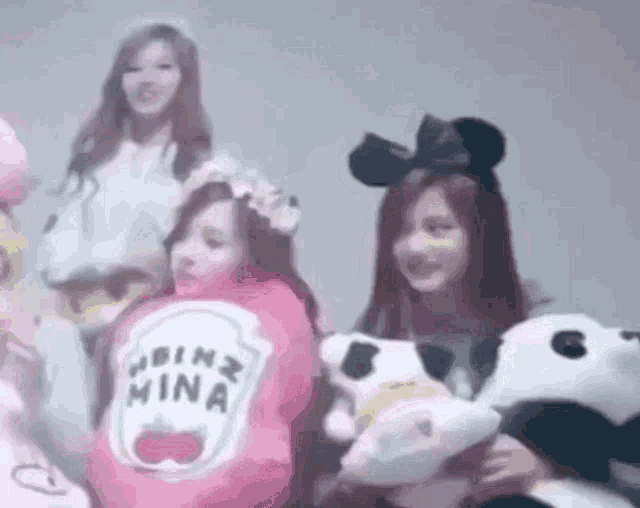 a group of girls are posing for a picture while wearing costumes .