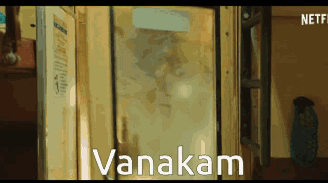 the word vanakam that is on a glass door